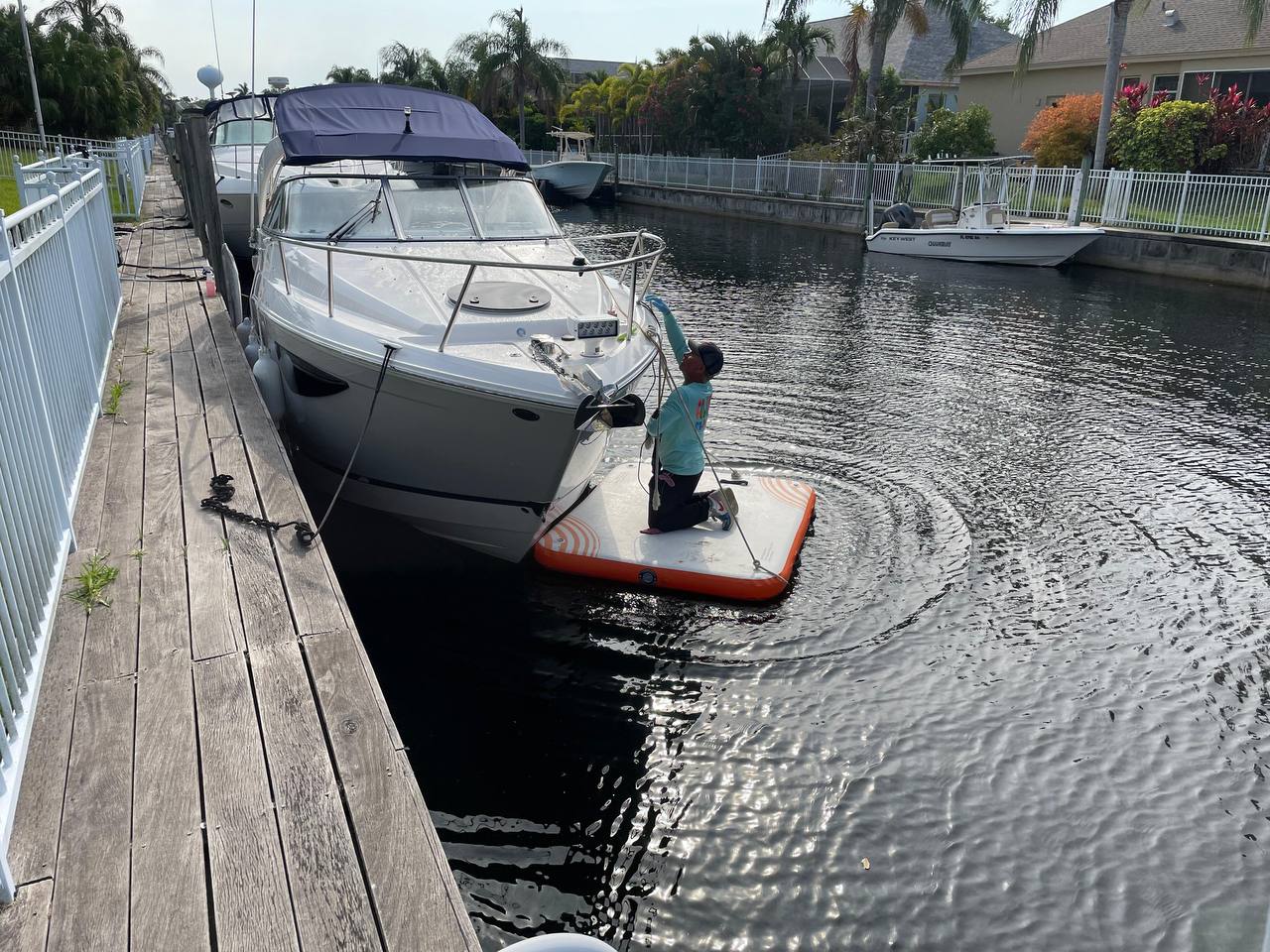 Dockside bow cleaning on a boat in a residential canal