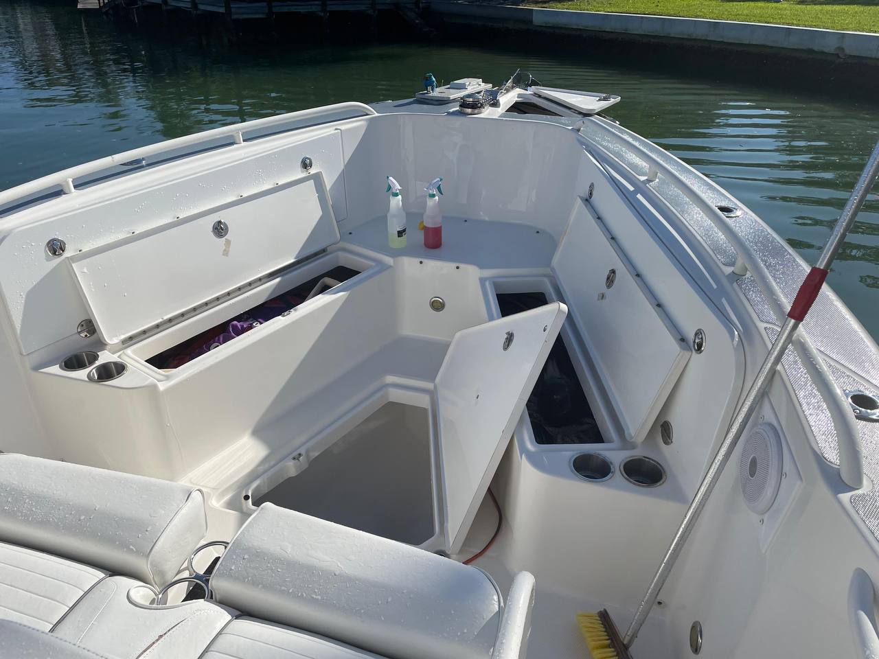 Open boat hatches and clean white deck surfaces after washing